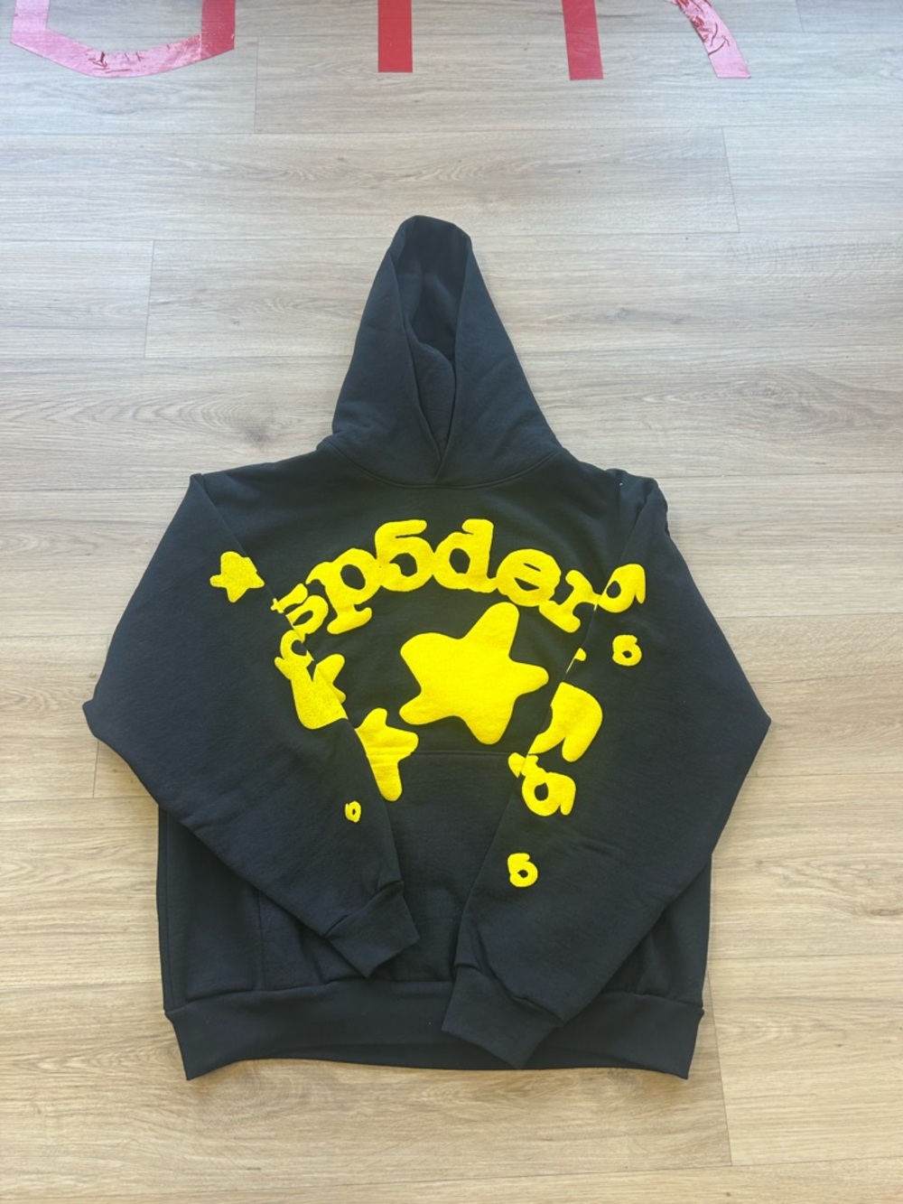 Black Hoodie with Yellow Star Graphic